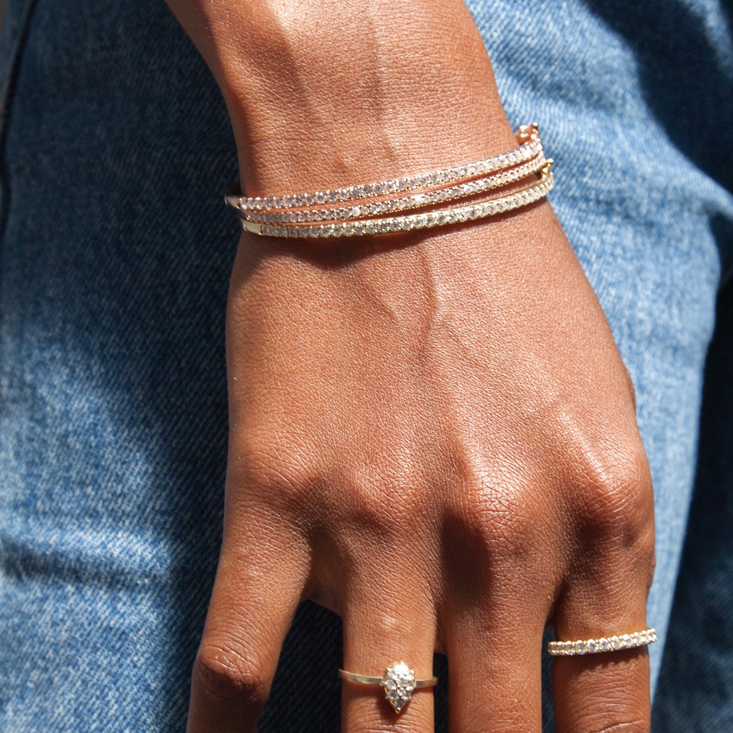 Here, all three colors of the Classic Diamond Bangle are shown stacked together for extra sparkle.