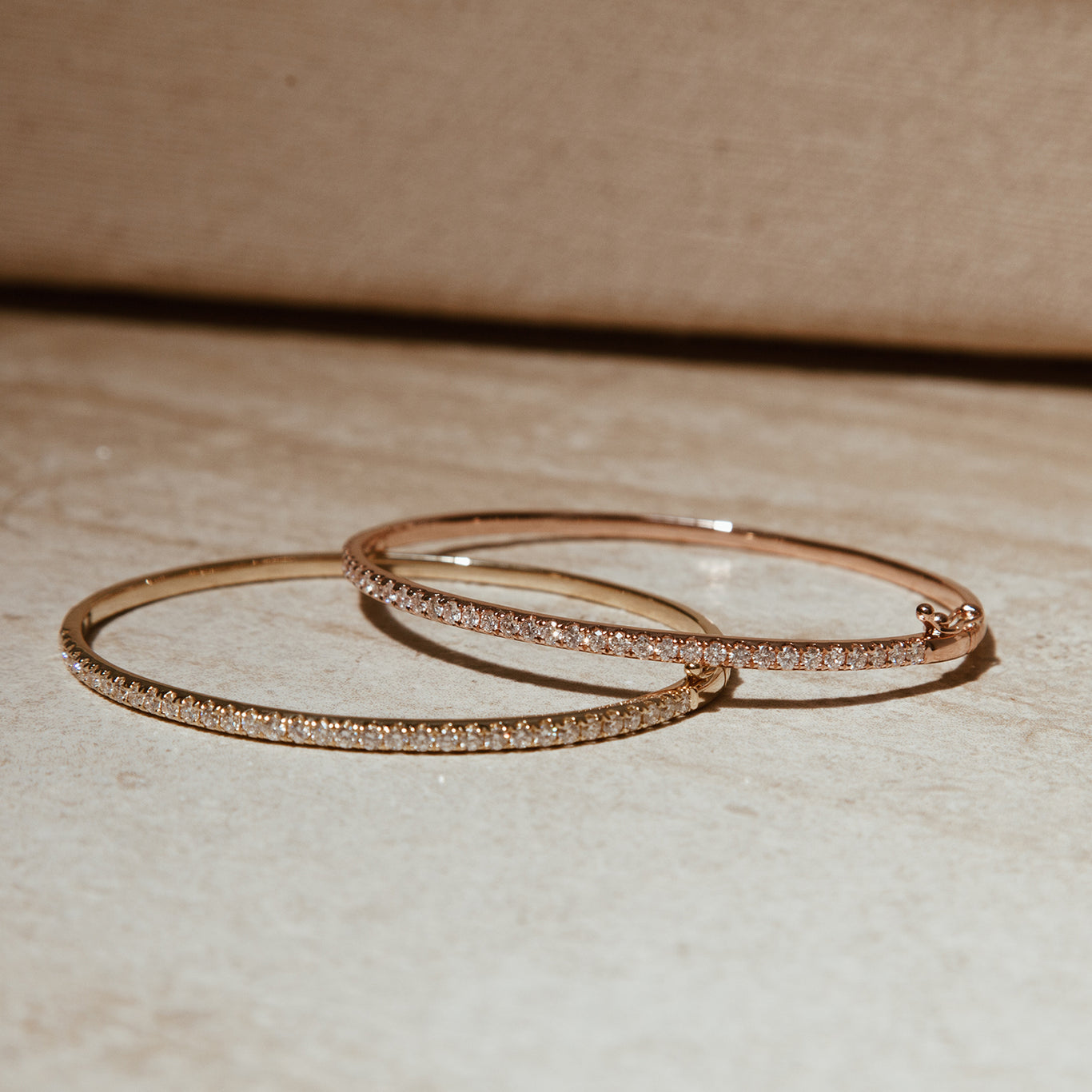 The Classic Diamond Bangles shown in rose and yellow gold.