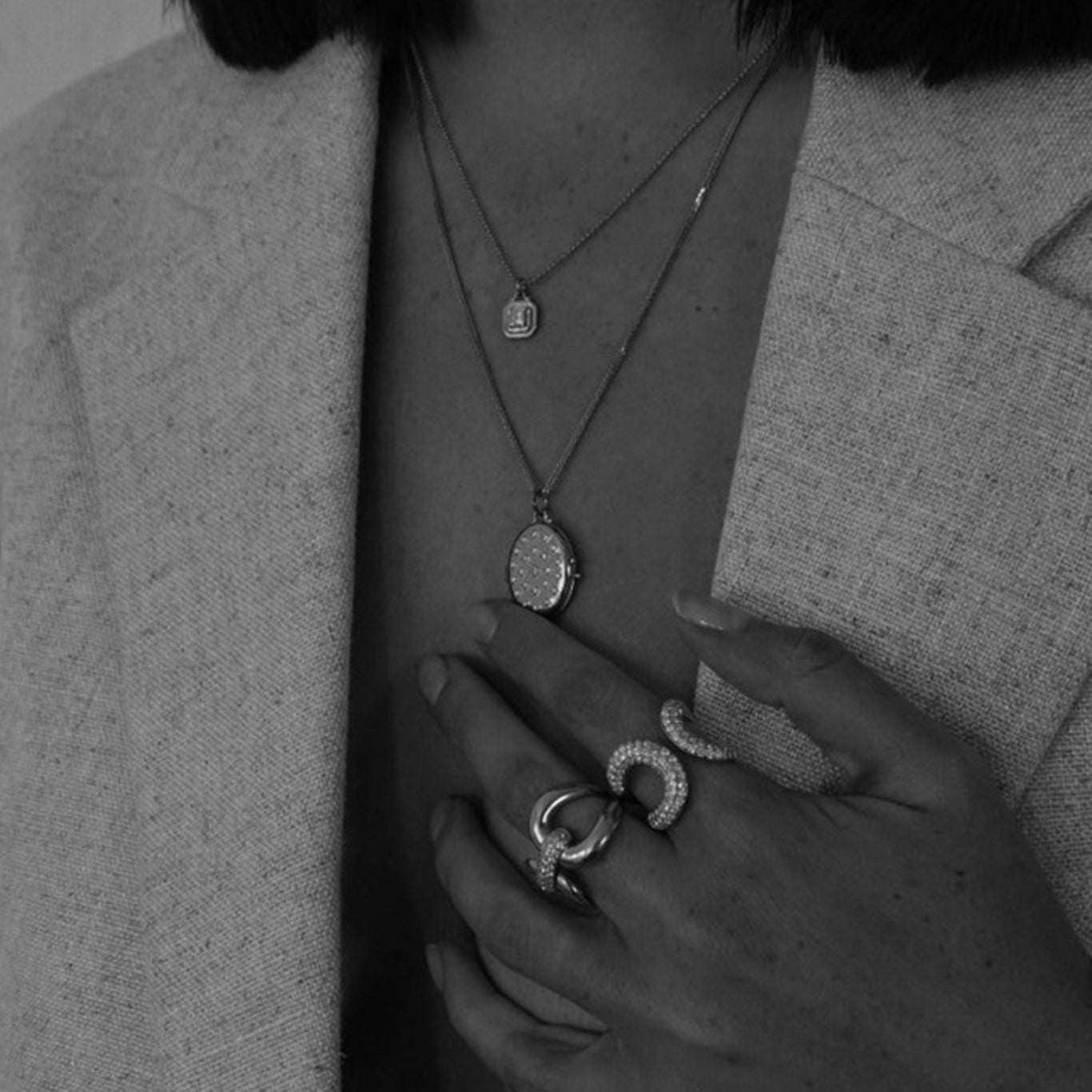 Comet Necklace shown with the Etoile Locket, Medusa Ring, and Love Lock Ring
