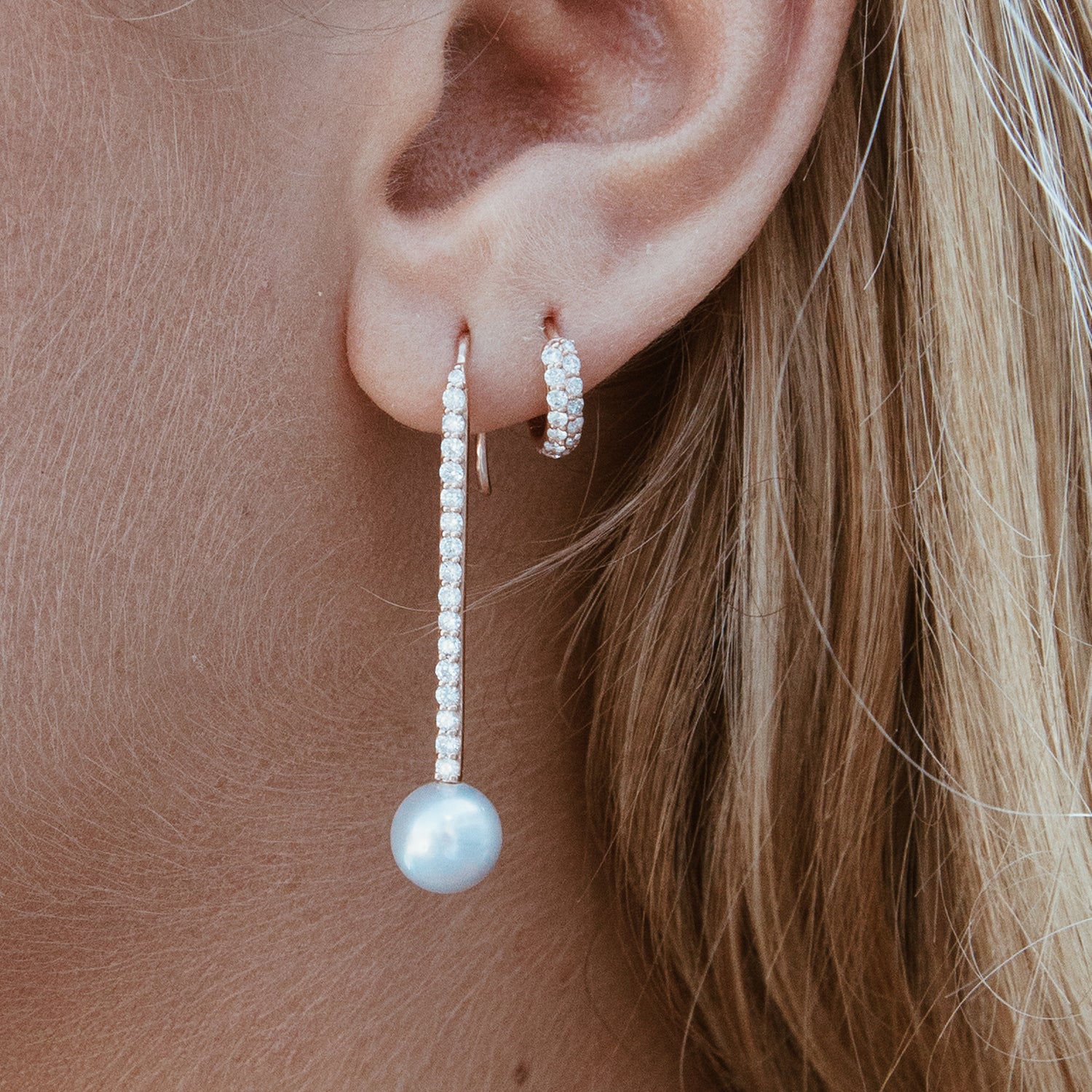 The Boom Huggie shown next to our Diamond Pearl Stick Earrings.