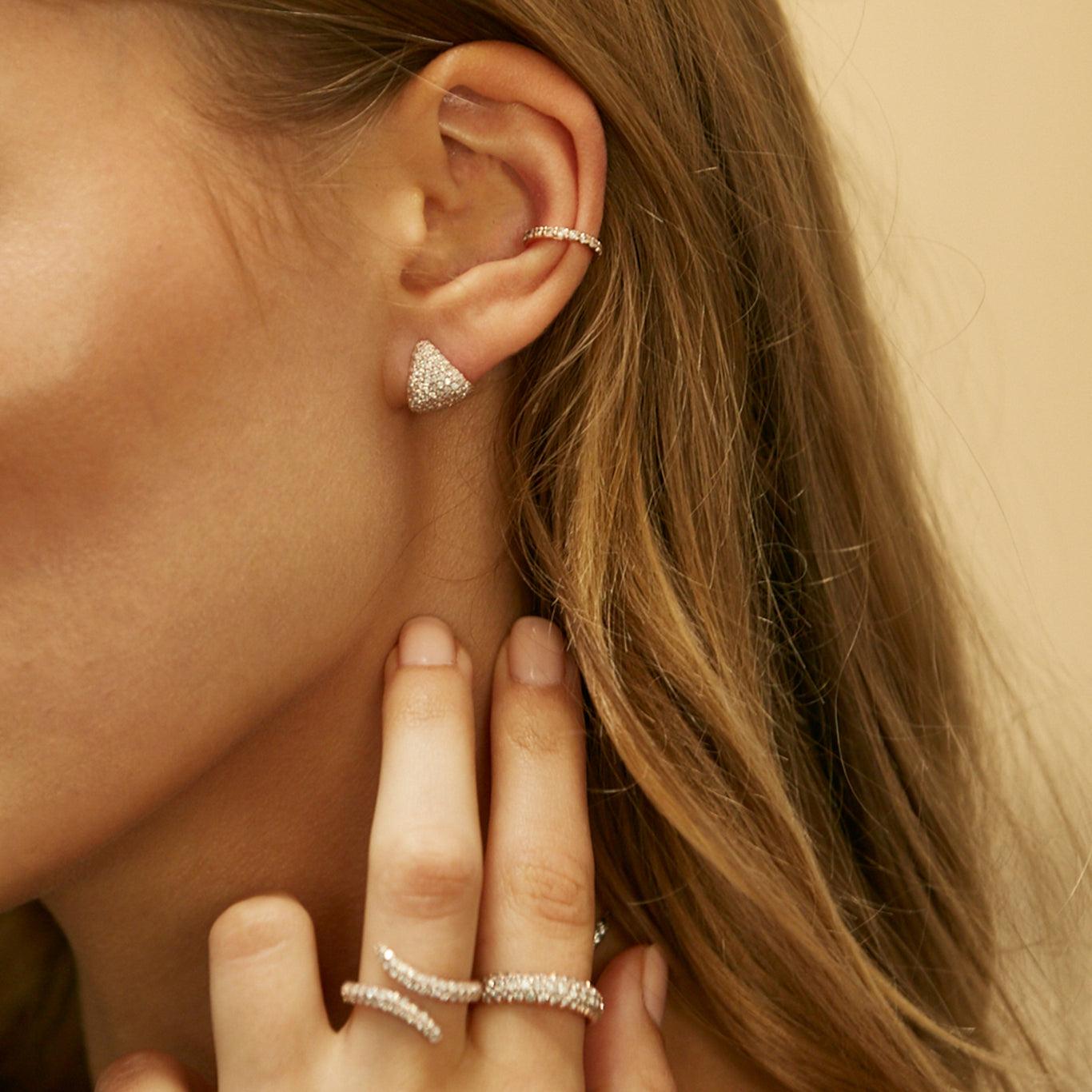 The Diamond Earring Cup shown with the Classic Cuff. Additionally, the model is wearing our Viper Ring and Dome Band on the hand.
