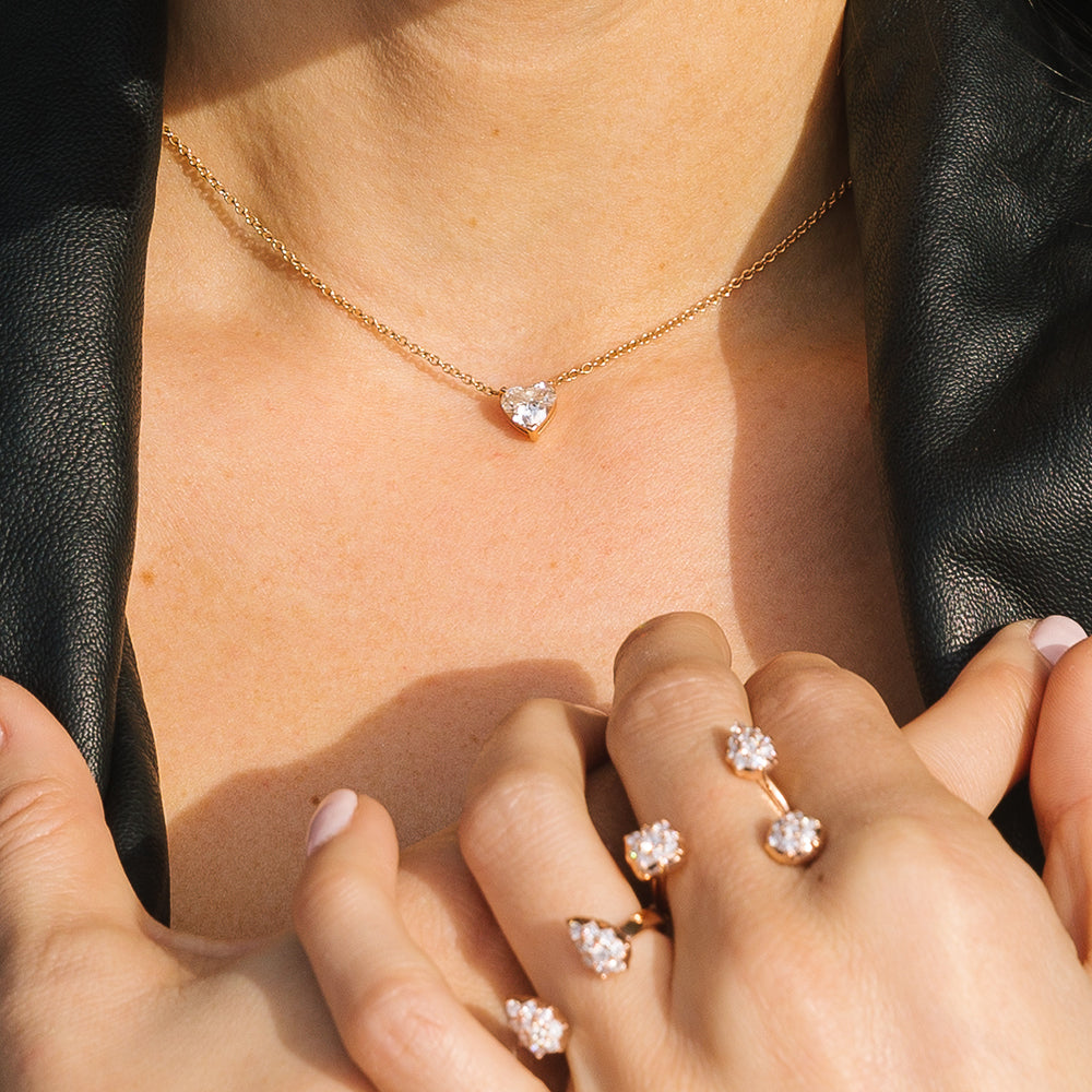 The Floating Diamond Heart Necklace shown with our Throne Ring and Stella Ring. The perfect delicate look for any occasion.