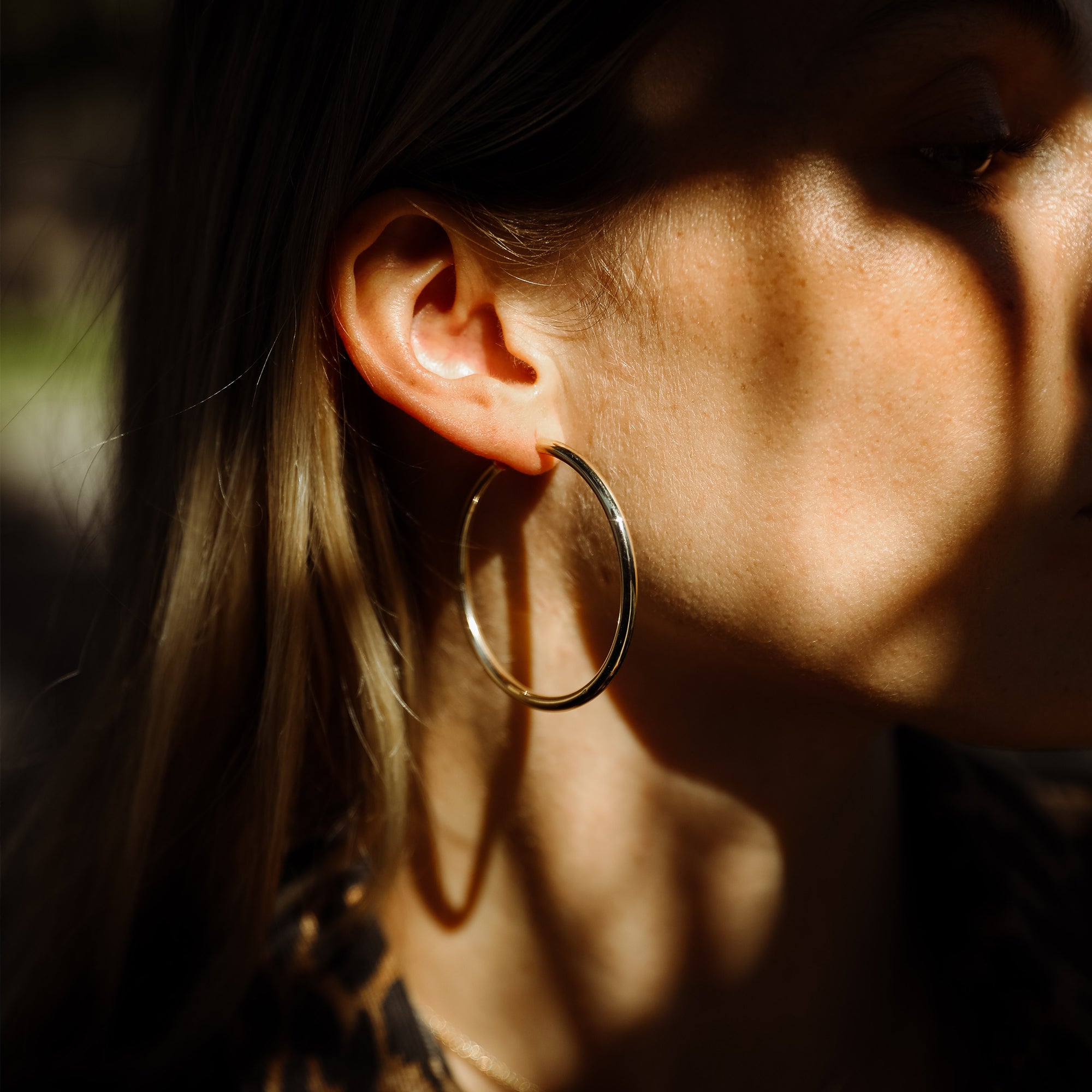 The 5cm Tube Hoops shown modeled in yellow gold.