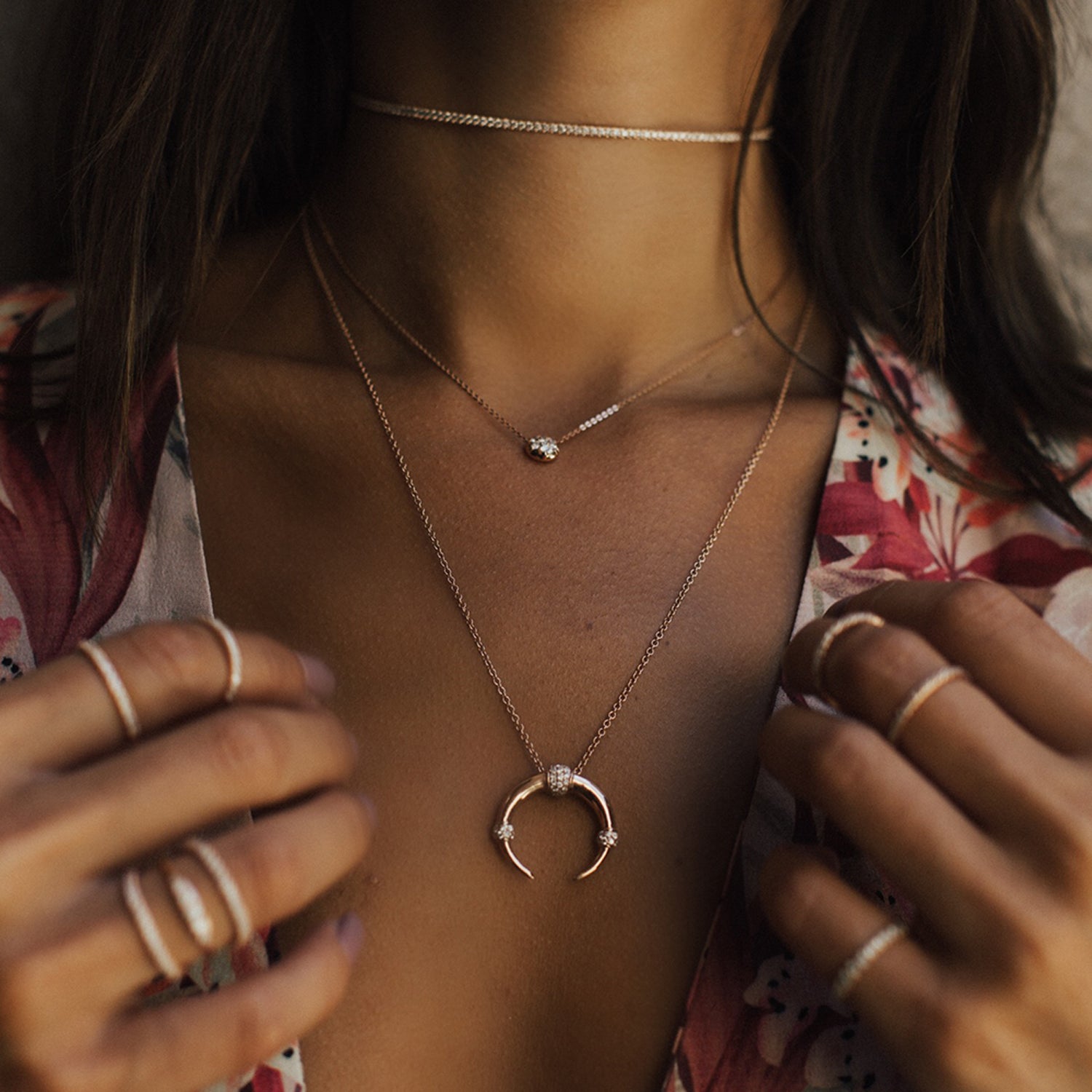 The Dharma Necklace shown layered with the Bullet Choker and Infinity Choker in rose gold.
