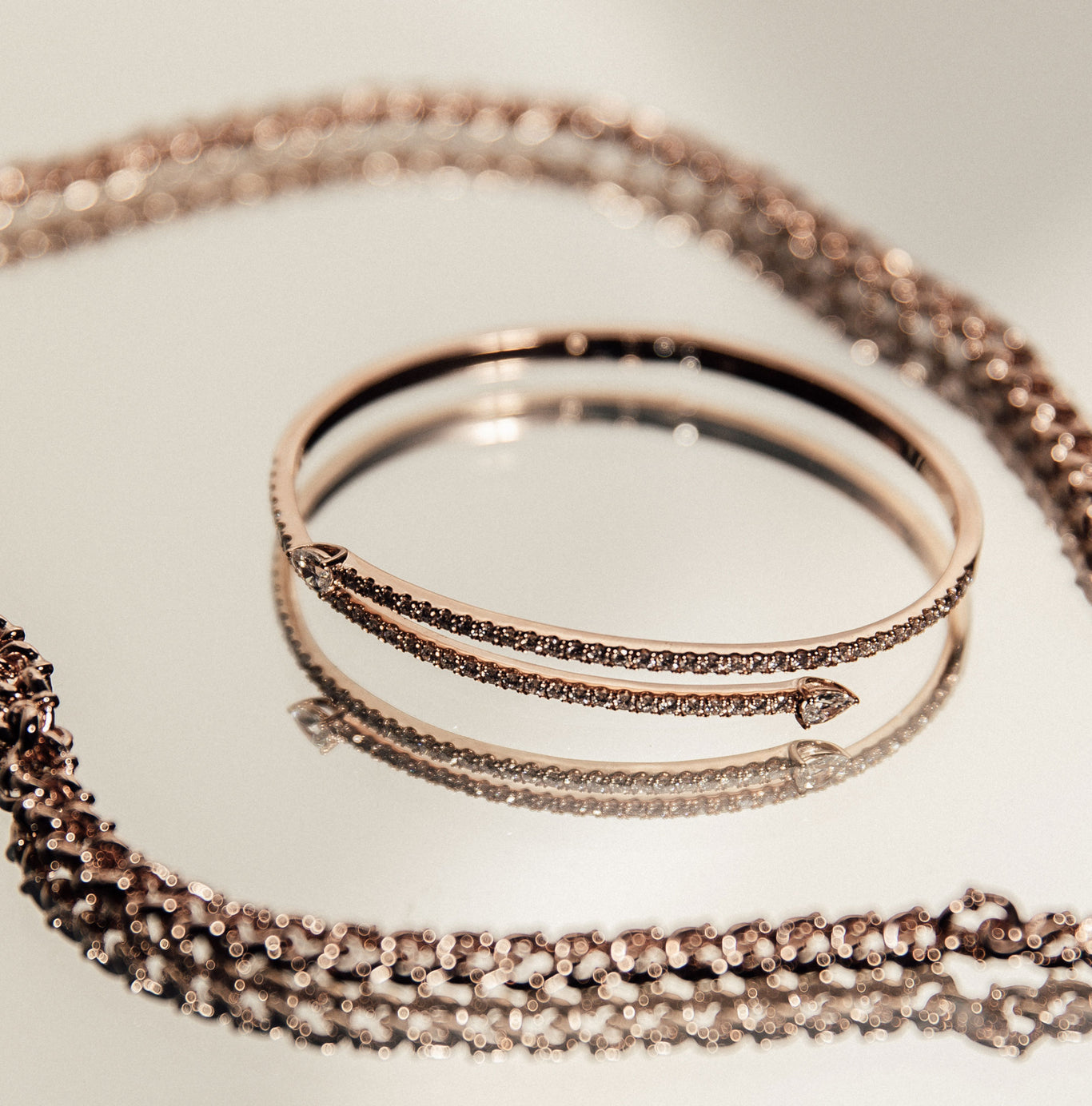 The Neptune Bangle shown next to the Tag Necklace.