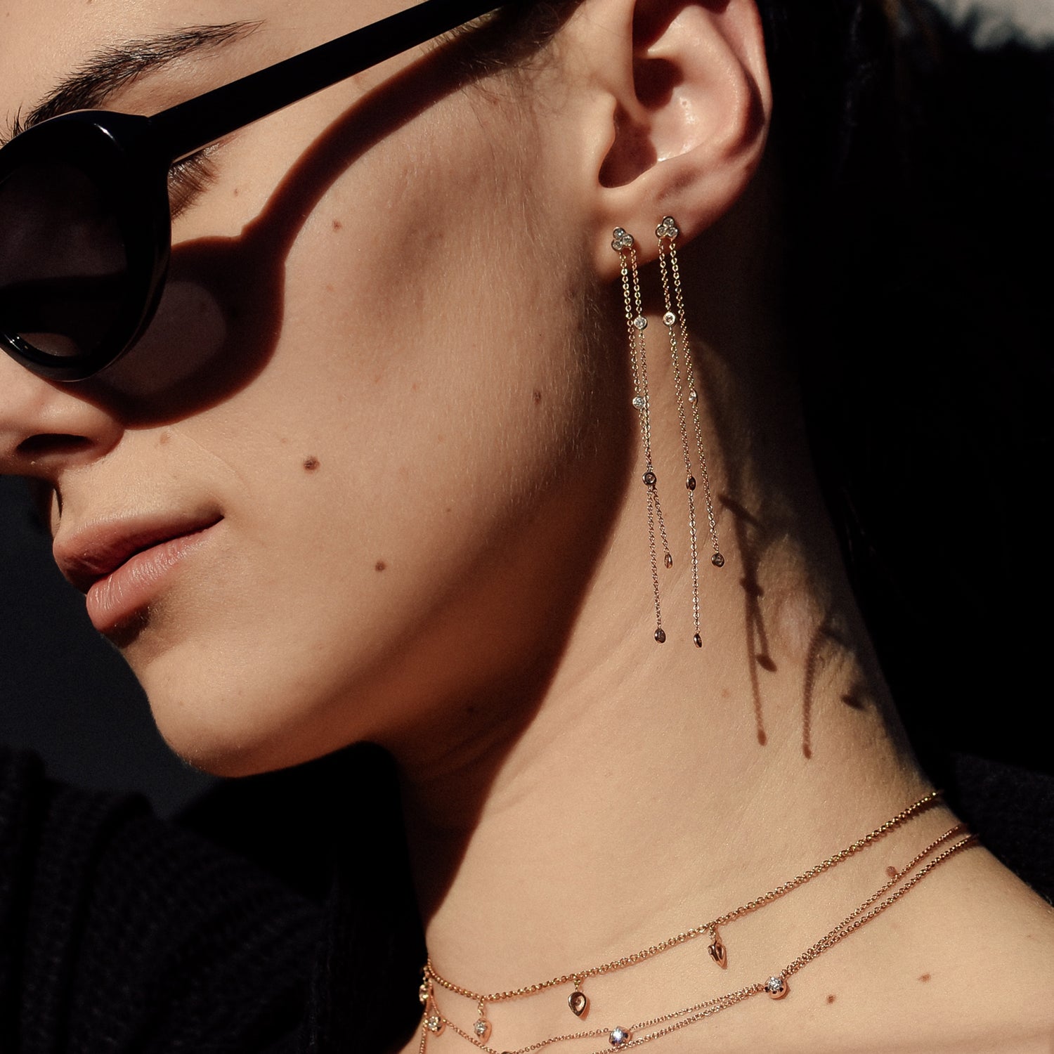 A pair of Poppy Earrings shown stacked on the ear in rose gold. 