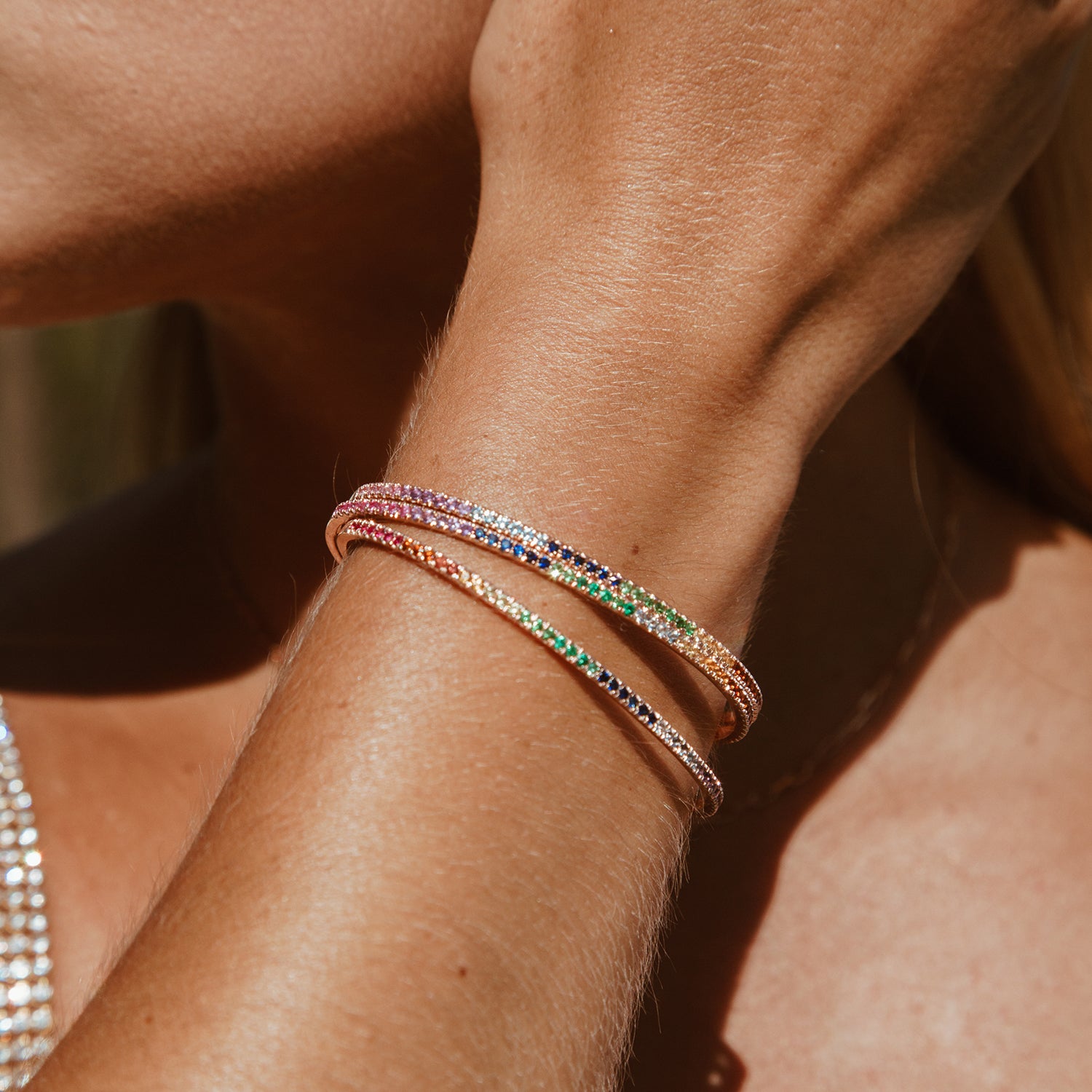 Three Rainbow Bangles shown stacked together in rose gold. 