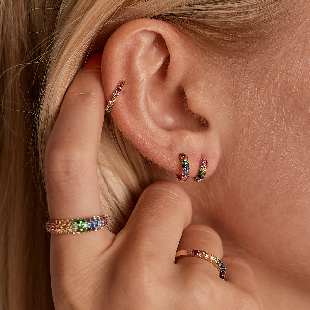 A pair of Rainbow Boom Huggies shown on the ear with our Rainbow Classic Cuff. The perfect pop of color to your look!