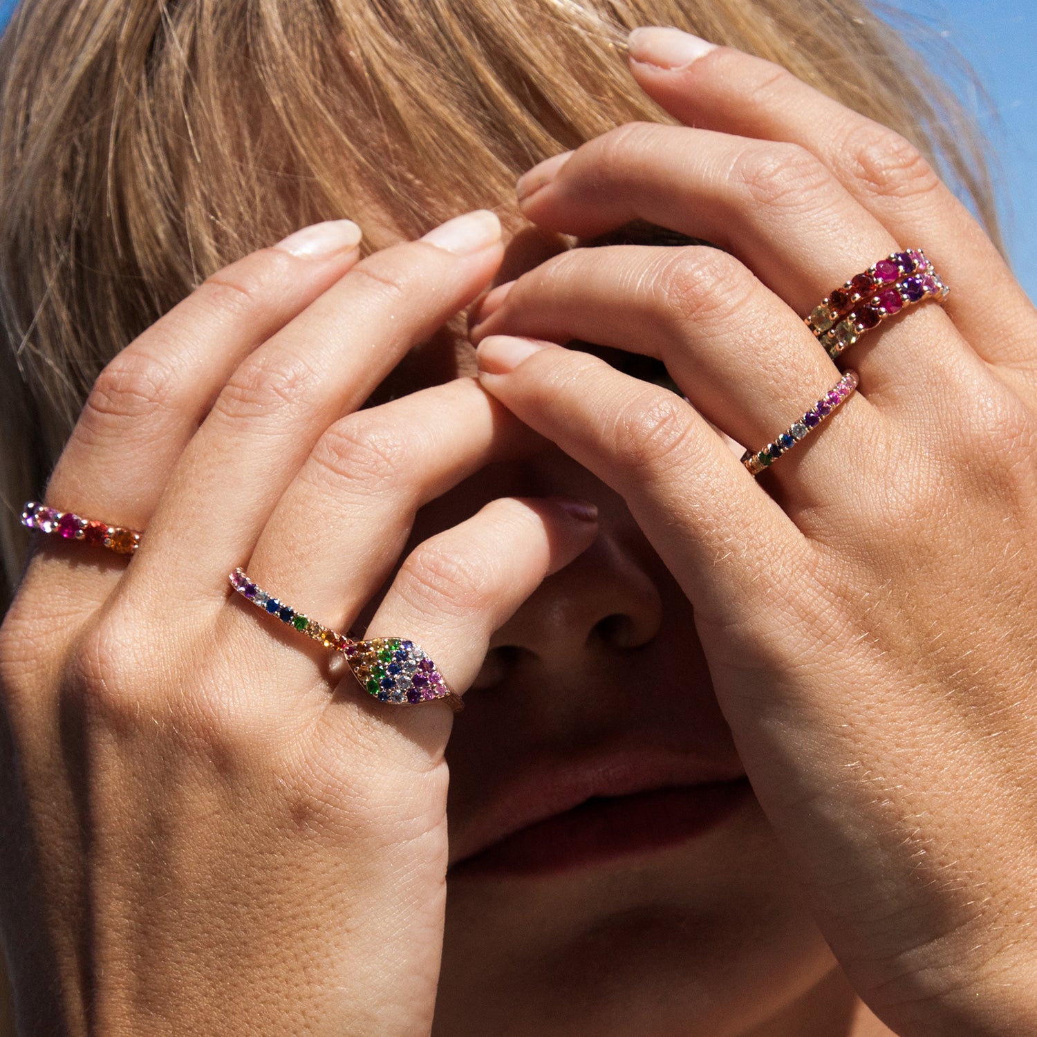 The Rainbow Gemma Pinky Ring shown making a colorful statement with our Rainbow Bands and Rainbow Eternity Bands on each hand.