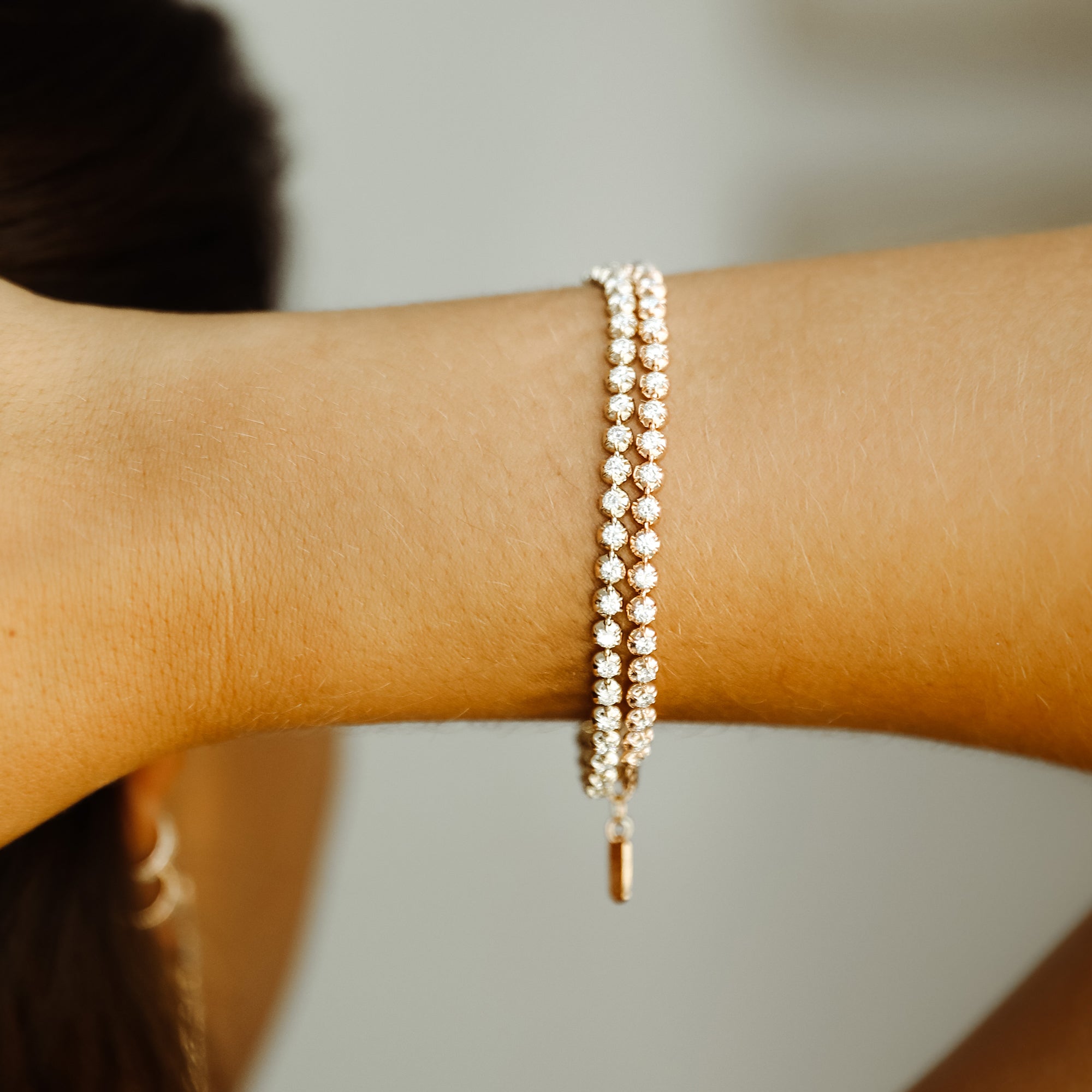 The Rosette Tennis Bracelet shown in yellow gold and rose gold. 