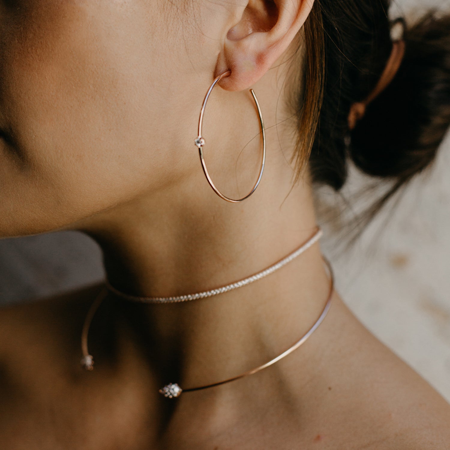 The Rosette Hoops shown modeled with the Infinity Choker and Rosette Choker. 