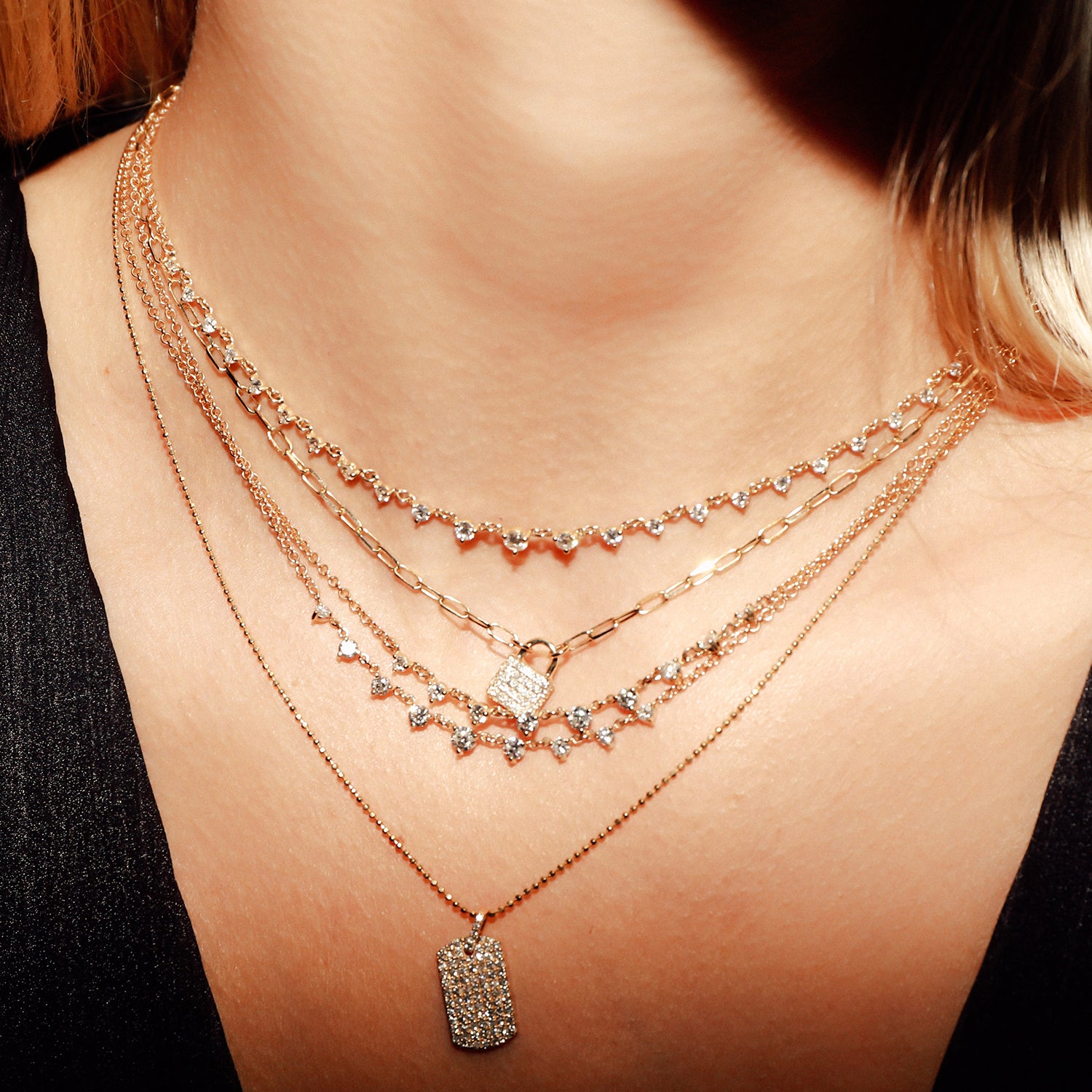 Our Starstruck Necklace shown layered with the Padlock Necklace, Mini Starstruck Necklaces, and Diamond Dogtag Necklace. 
