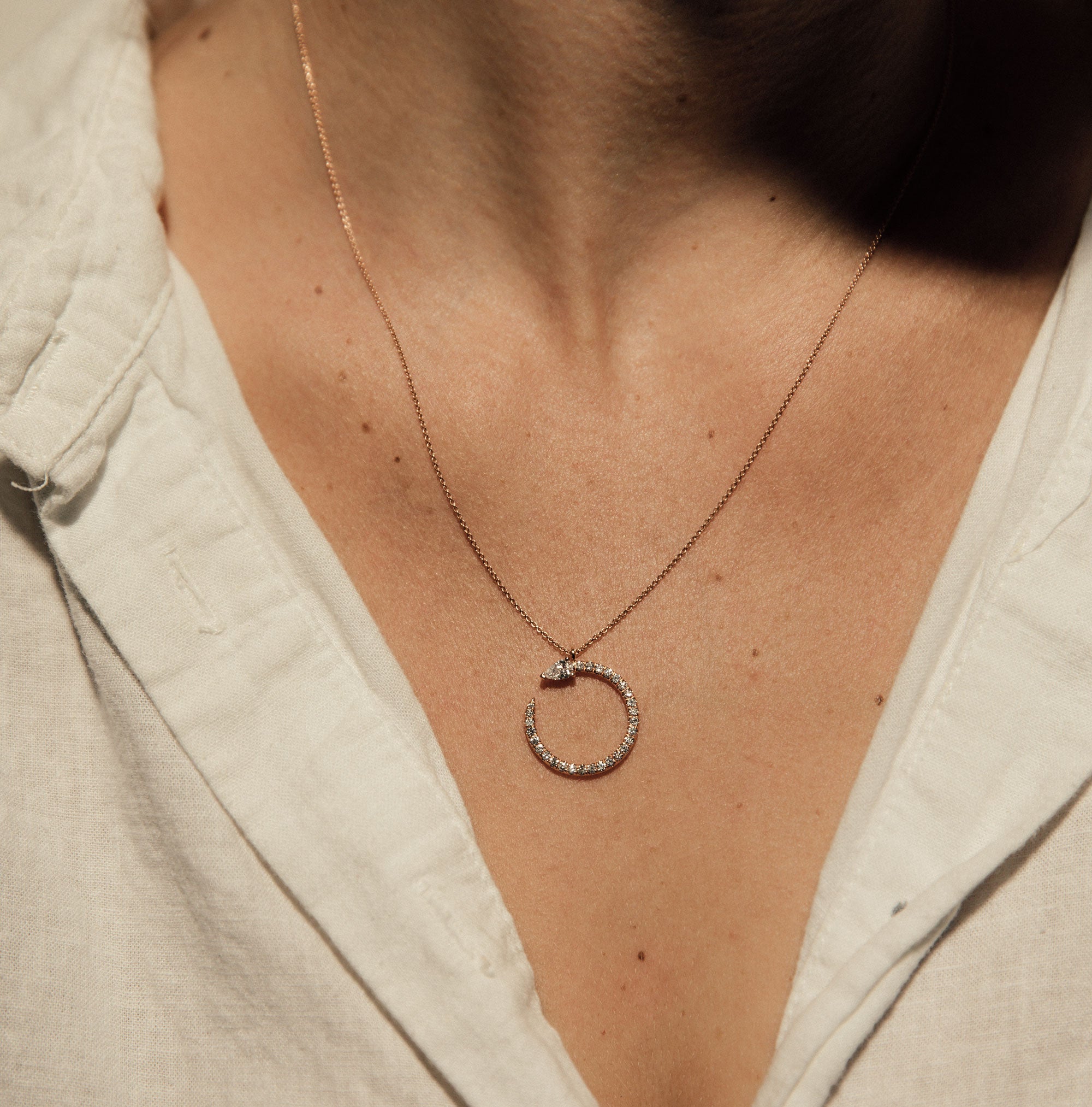 The Serpent Necklace shown modeled in rose gold. 