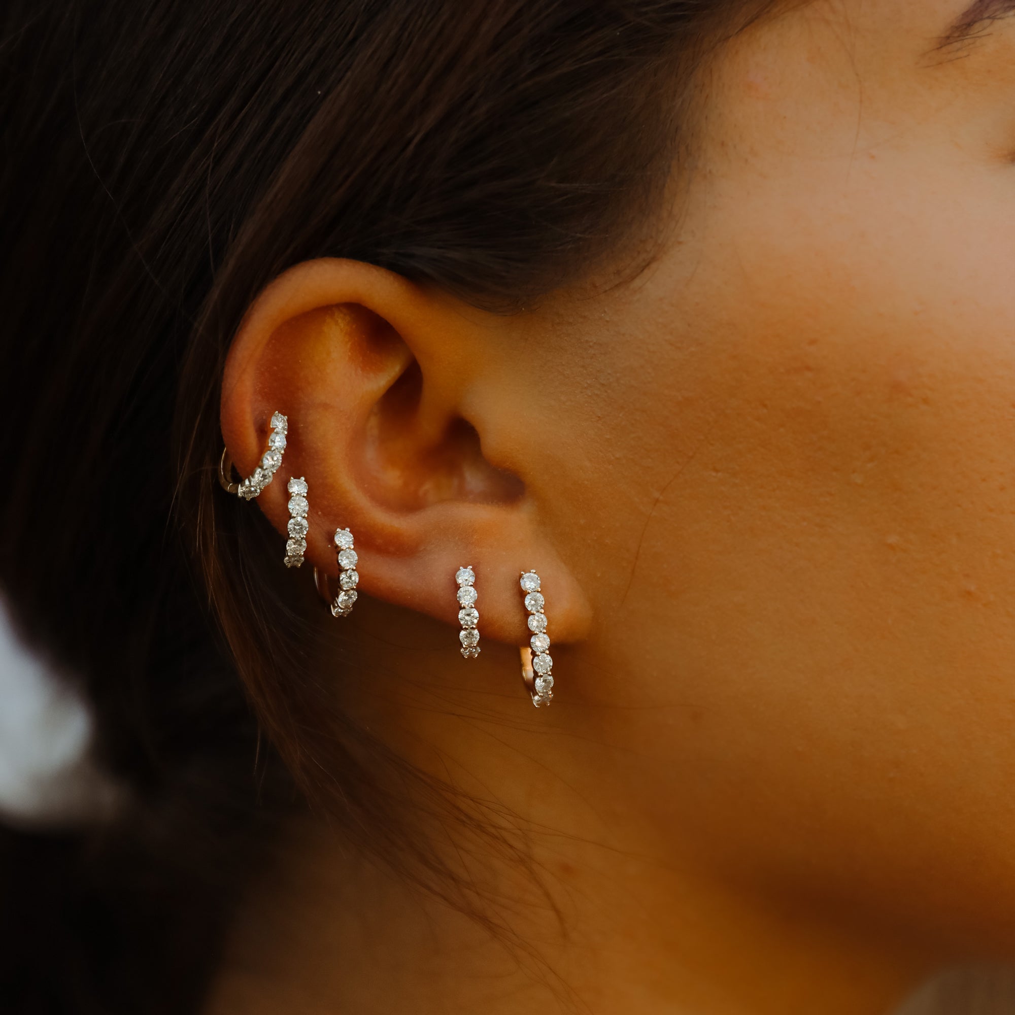 Our Sparkler Huggies shown stacked along the ear with the Sparkler Pin Earrings.