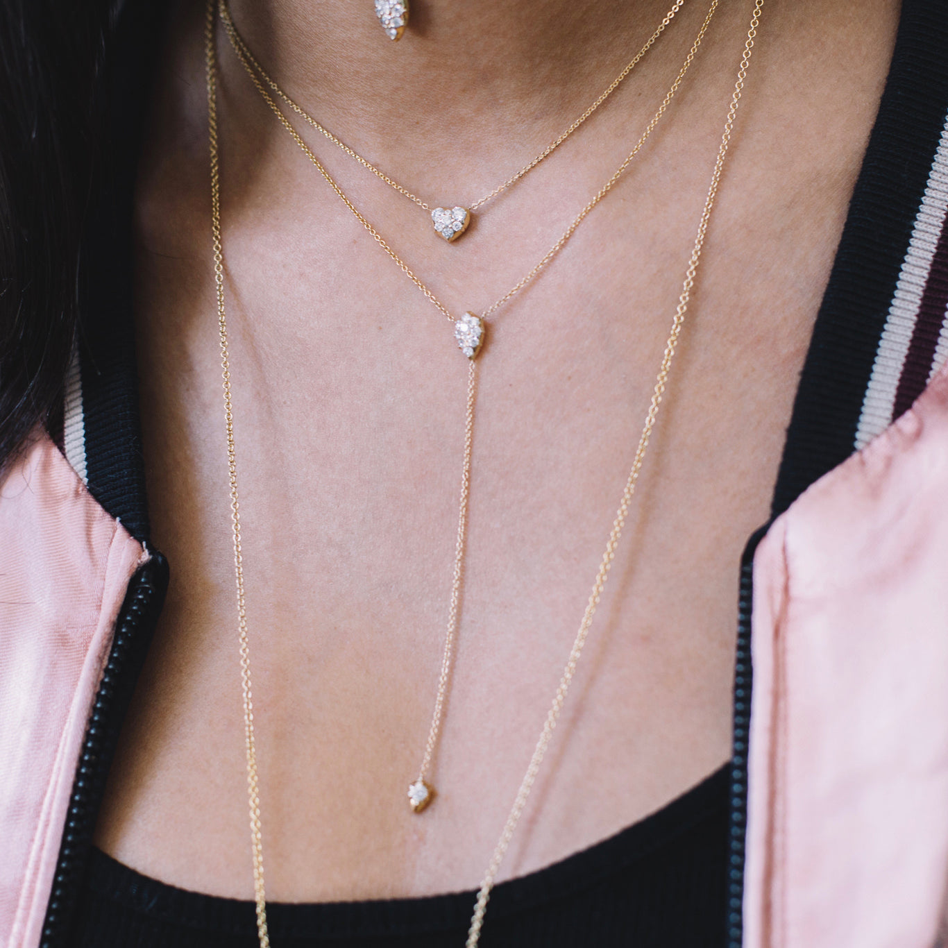 The Stella Lariat and Heart Choker Chain shown layered beautifully in yellow gold. 