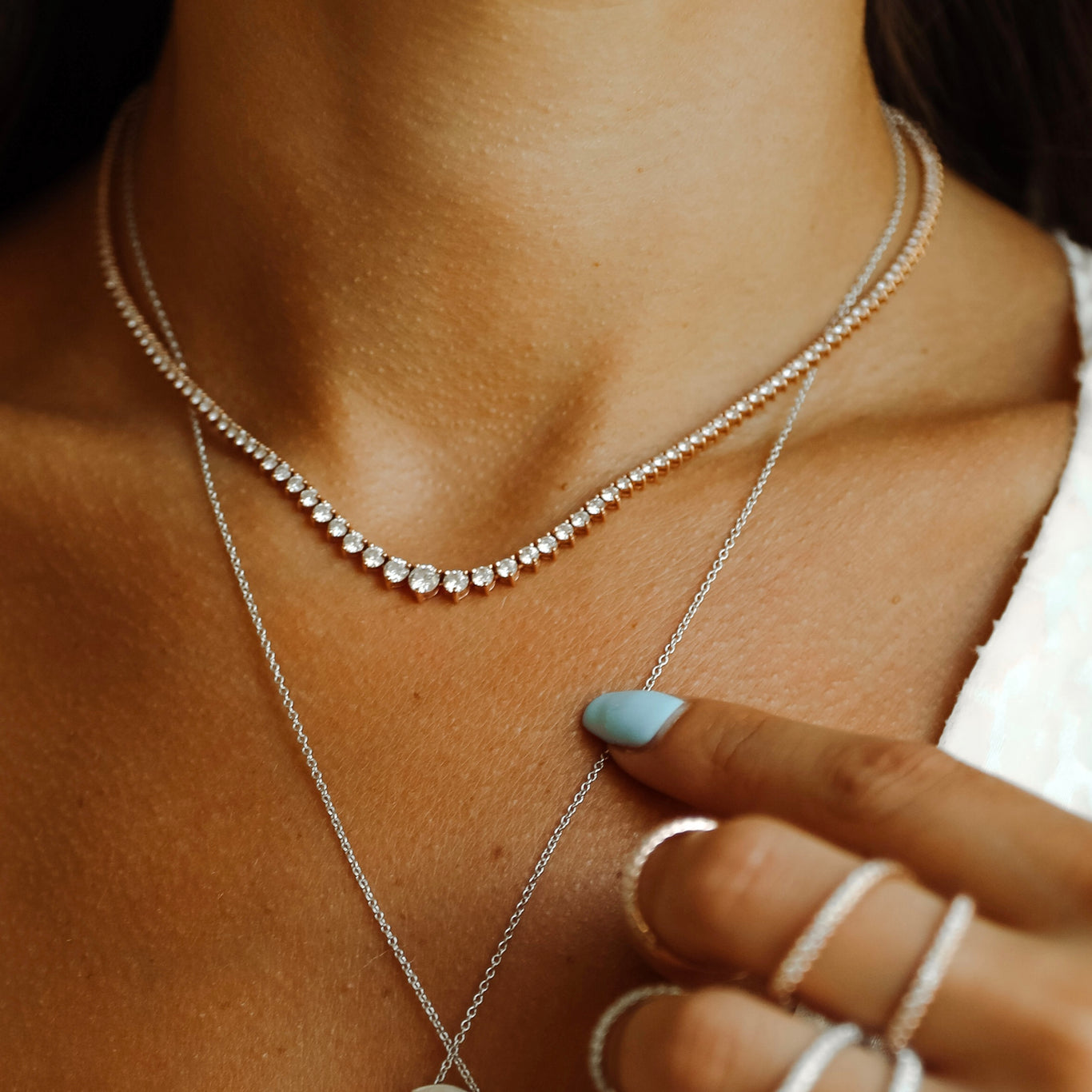 6.50 Carat Graduating Tennis Necklace shown worn with the Arabesque Ring.