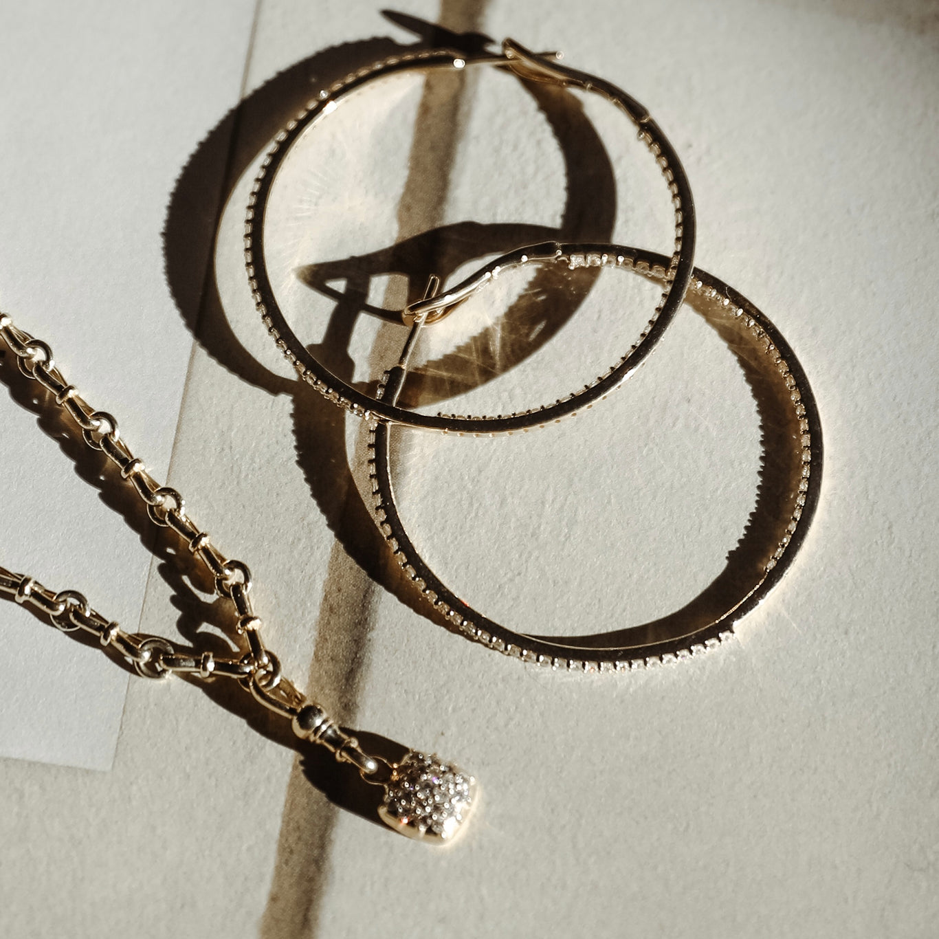 Trilogy Necklace shown with the Infinity Hoops