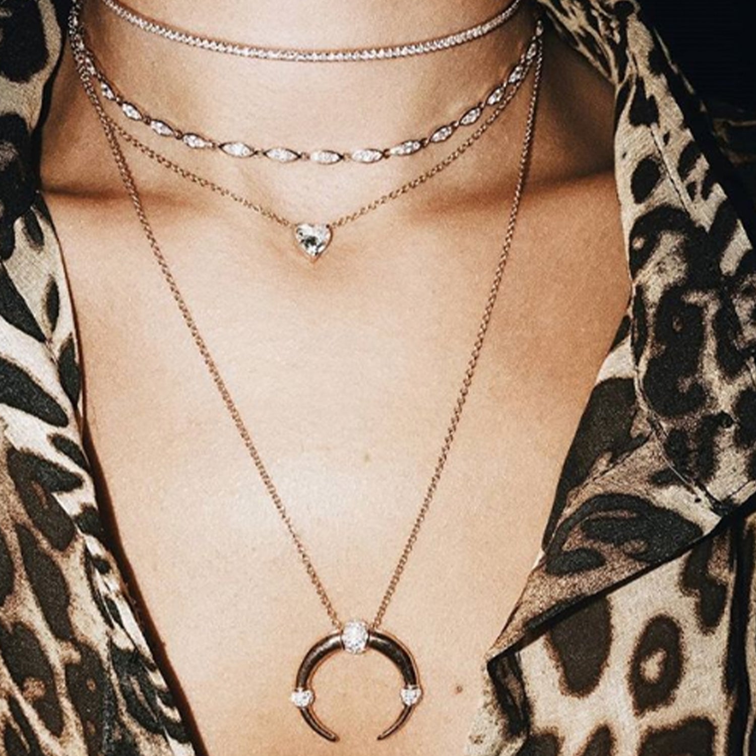 The Floating Heart Necklace shown layered with the Infinity Choker, Angel Choker, and Dharma Necklace.