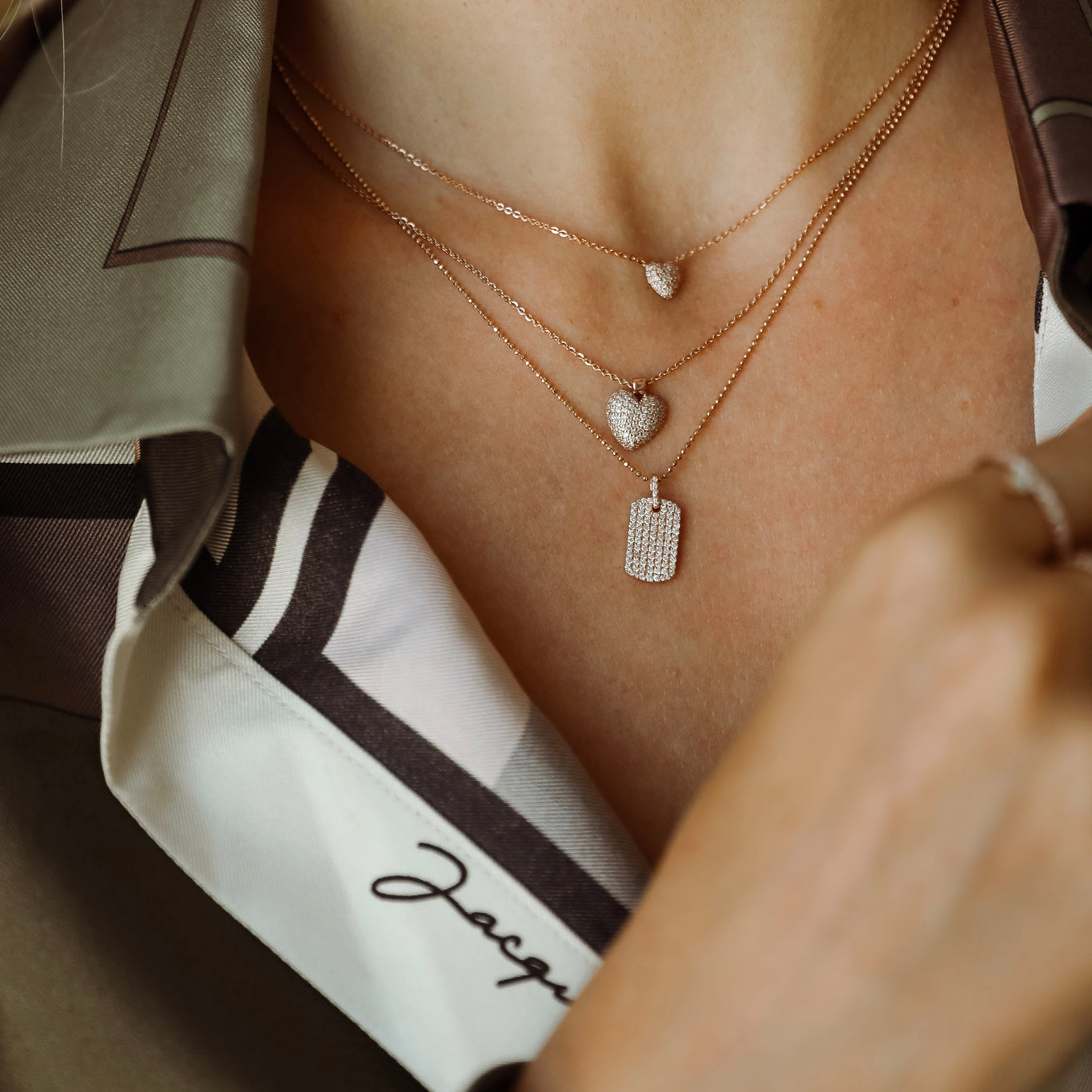 Diamond Dogtag shown layered underneath the Sweetheart Necklace and the Mini Sweetheart Necklace