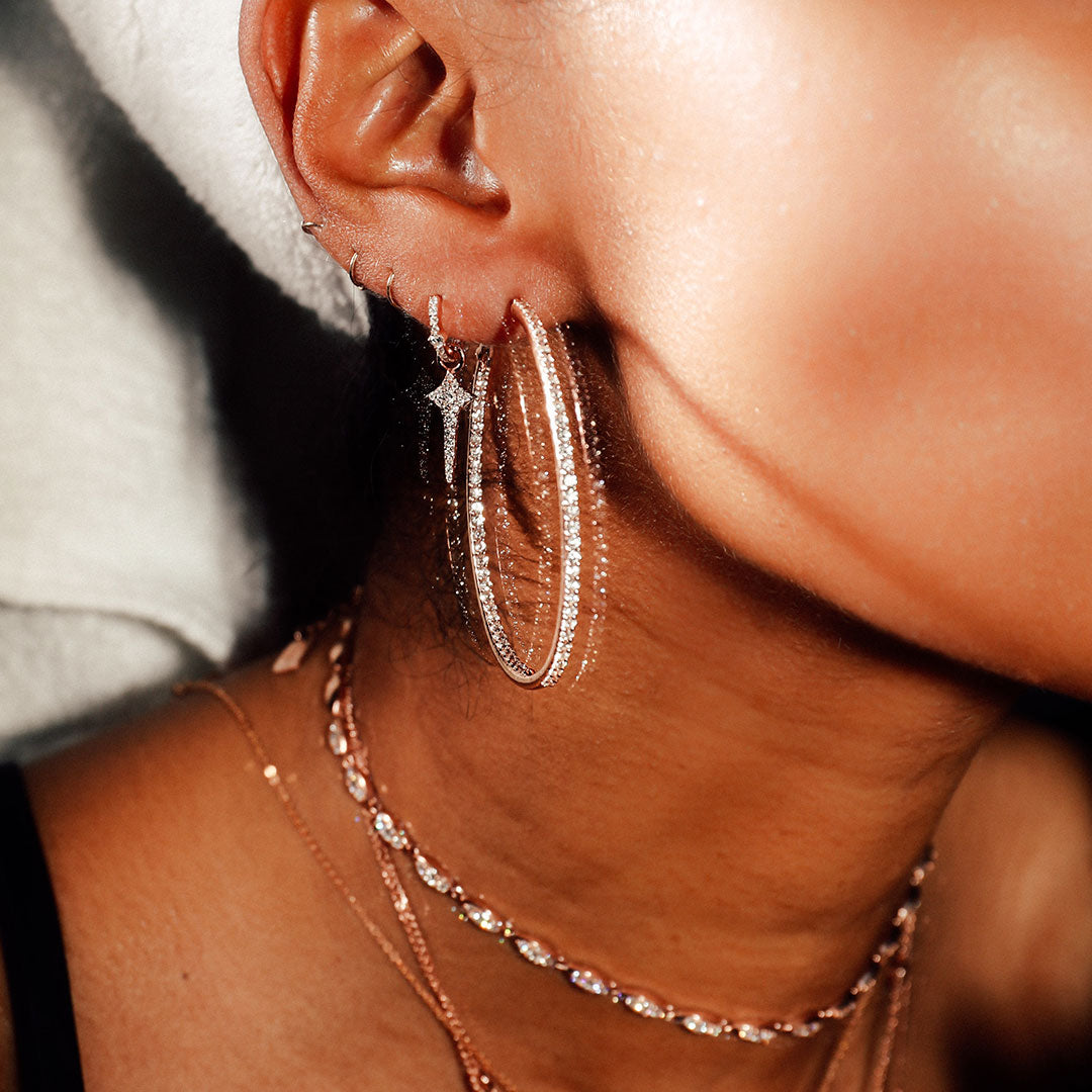 The Infinity Hoops shown with the Cross Dagger Huggy and Angel Choker.