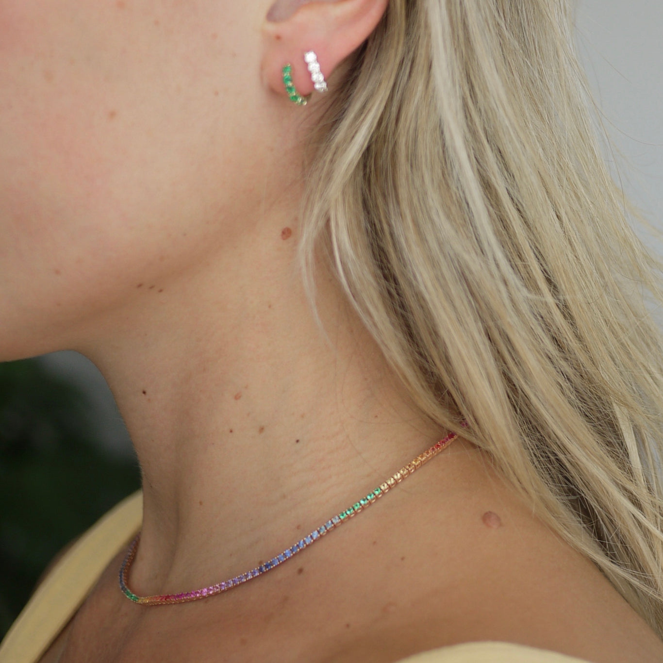 Rainbow Tennis Necklace shown worn with the Emerald and Diamond Sparkler Huggies